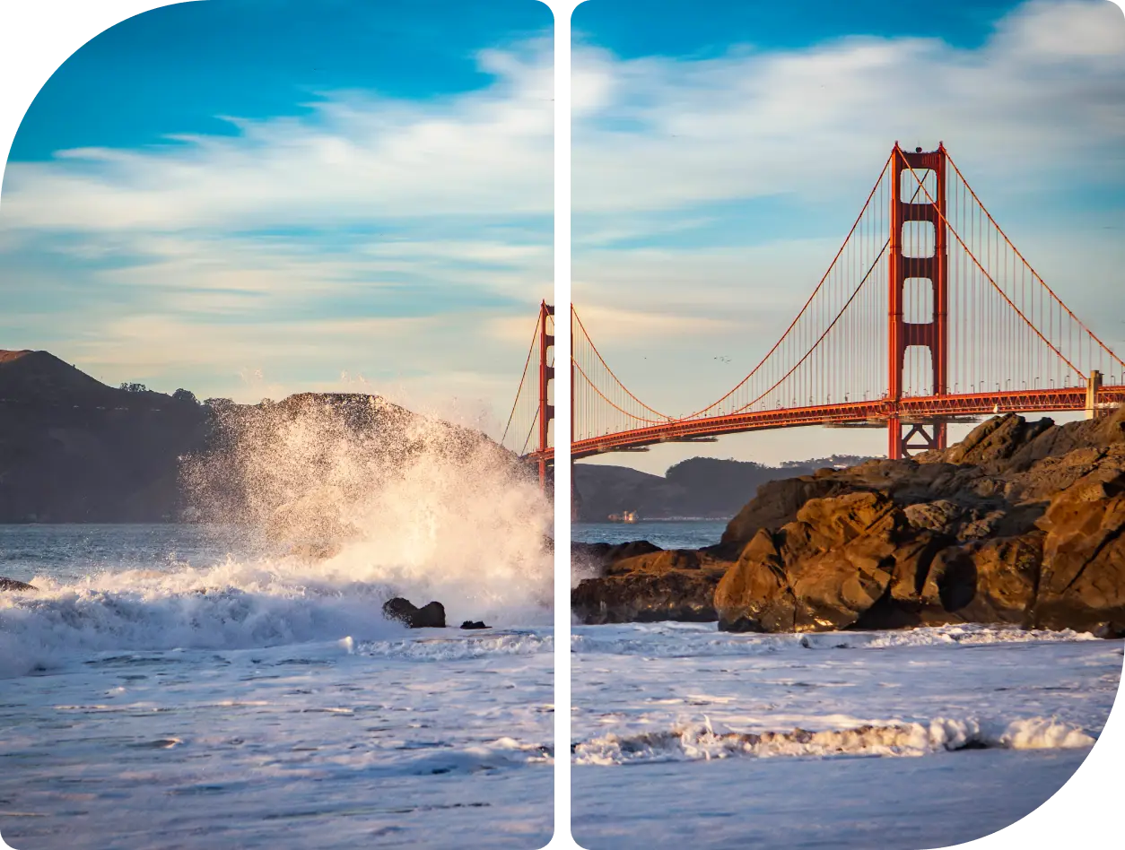 Golden Gate Bridge with waves crashing on rocks at sunset.