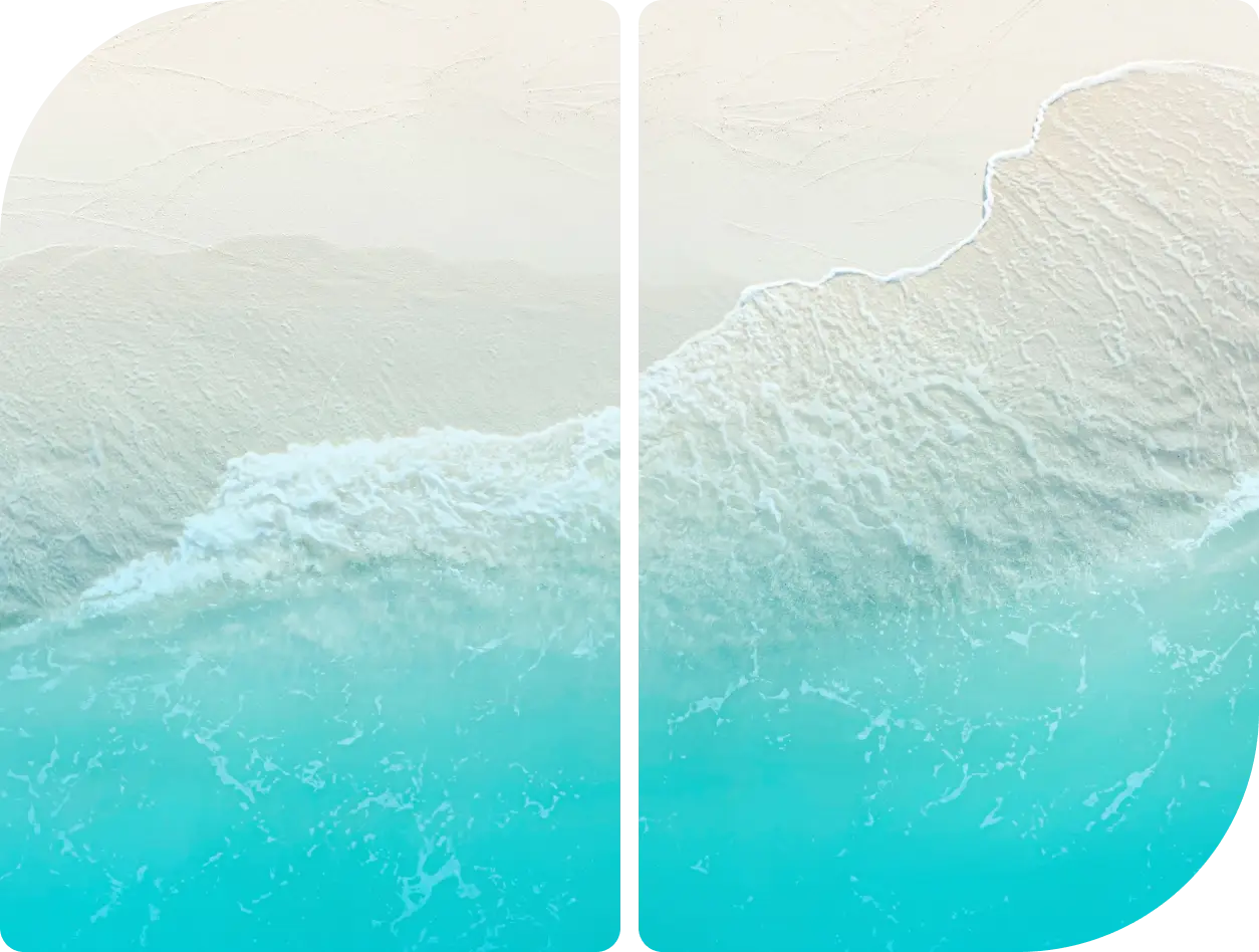 Aerial view of turquoise ocean waves meeting a sandy shore.